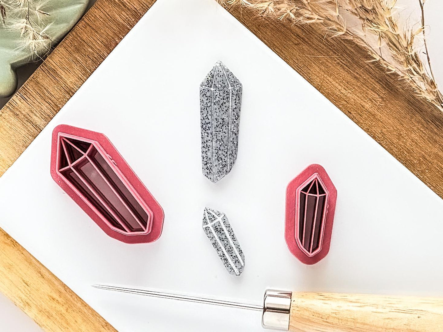 Small and large mystical crystal clay cutters on tile with sample cut out