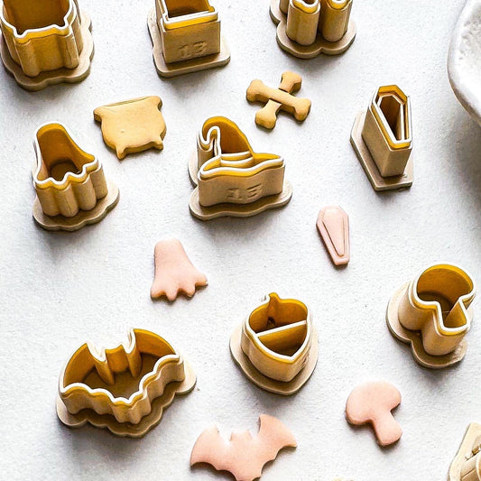 Close up of Halloween clay cutter set in beige with baked polymer clay pieces to demonstrate sharp and clear imprint lines.