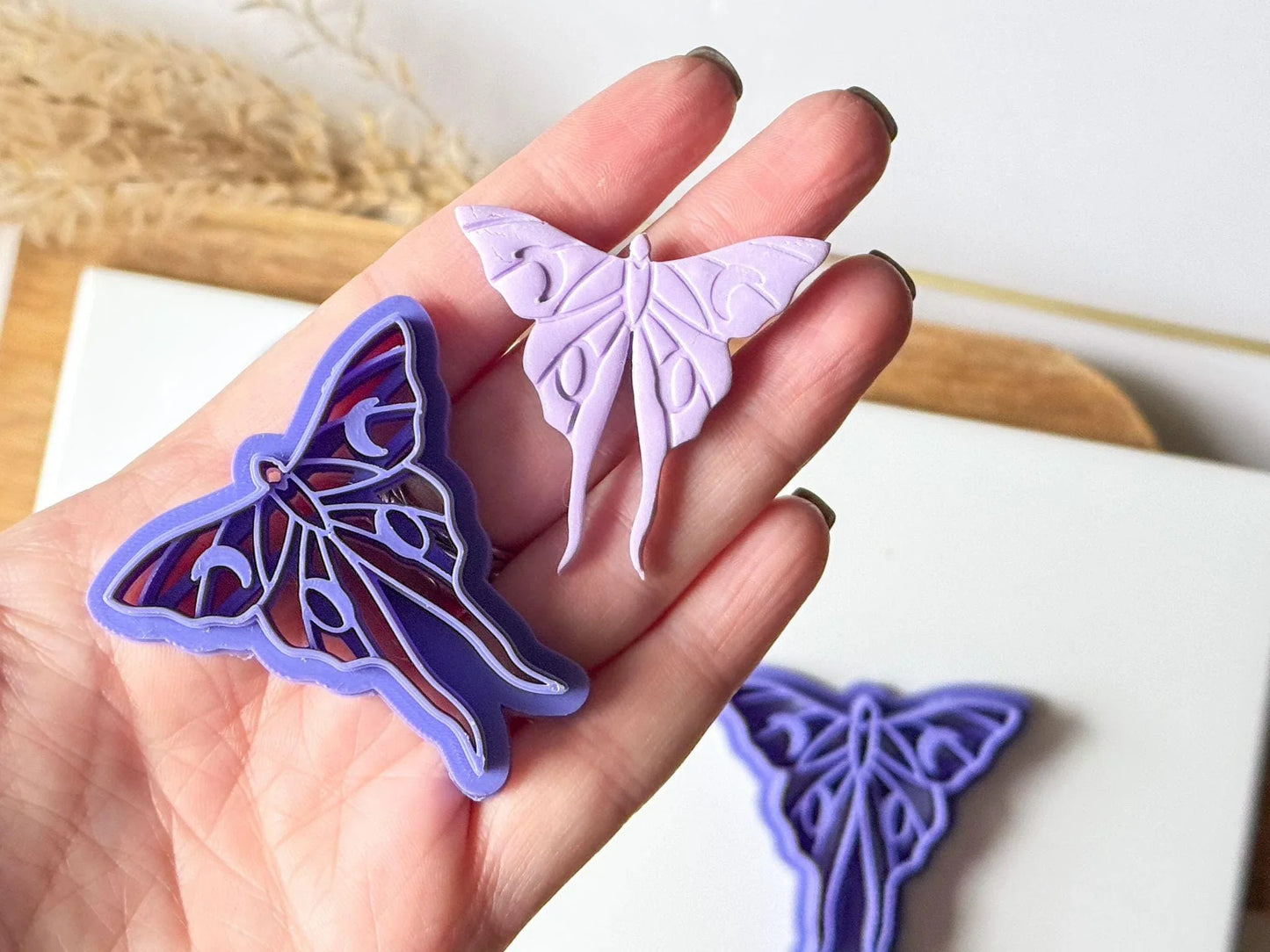 Moon moth clay cutter for polymer clay jewellery in hand for scale