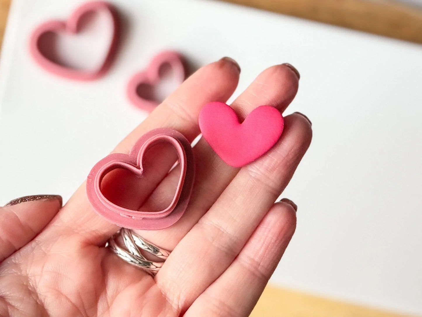 organic heart polymer clay cutters in hand