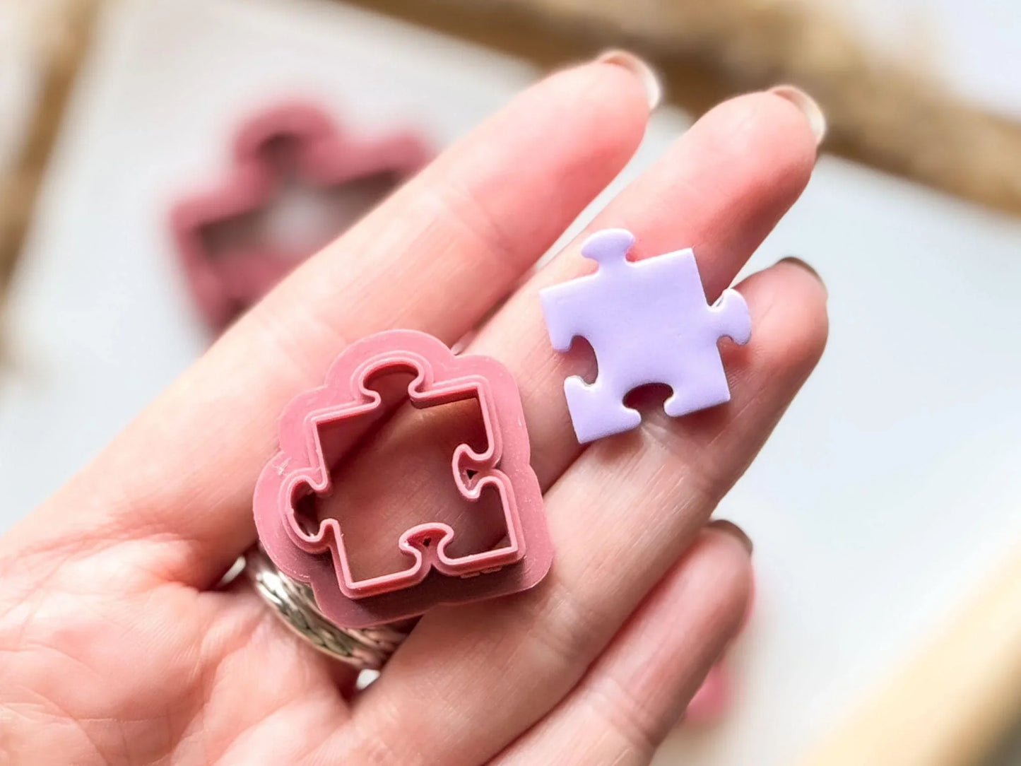 20mm jigsaw puzzle piece with cut out clay in hand