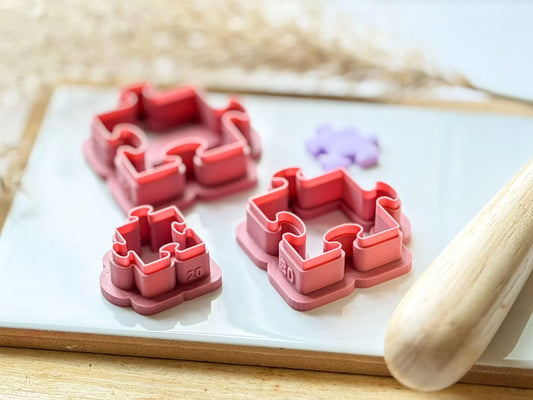 Side view of jigsaw puzzle clay cutters