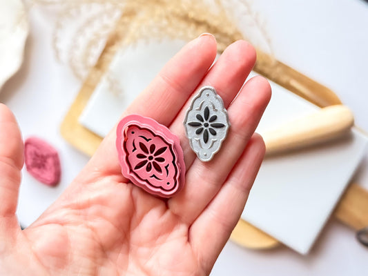 Pink debossingcutter for polymer clay with a clay cut out sample