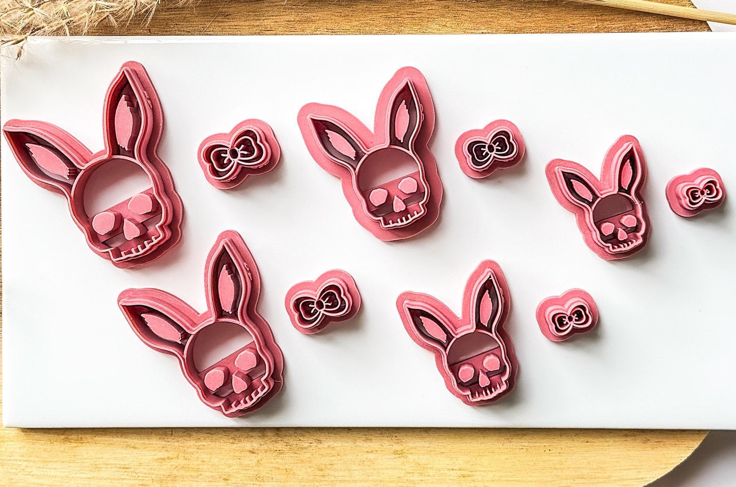 Multiple sizes of hell bunny easter clay cutter arranged on a white tile