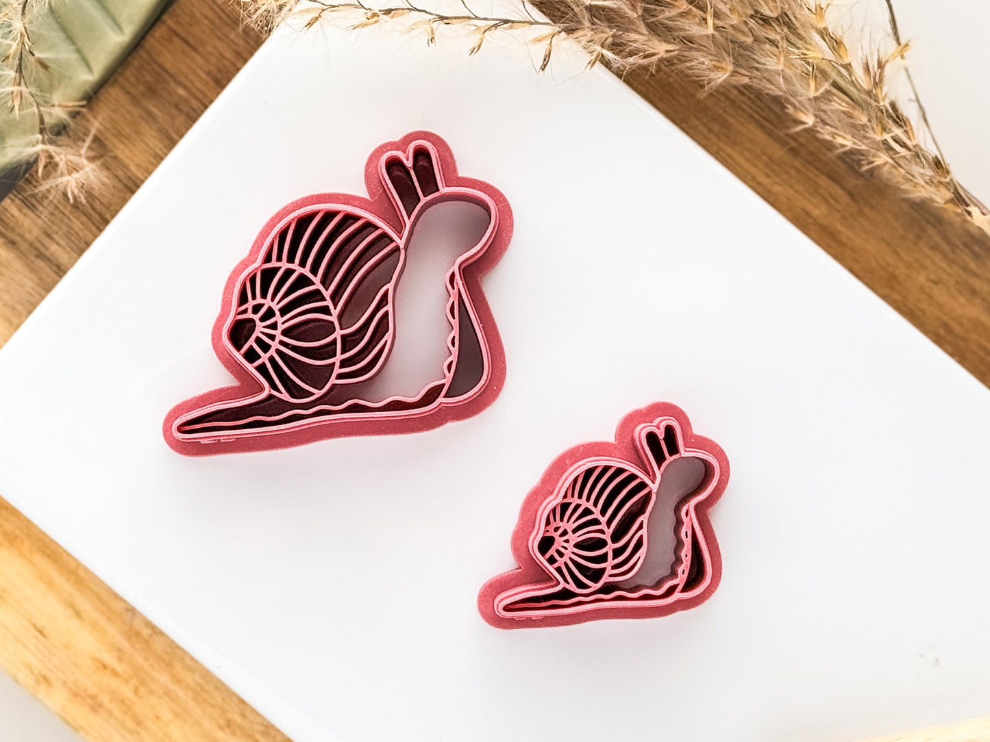 Detailed Clay Cutter Snail Shape in pink on a white tile