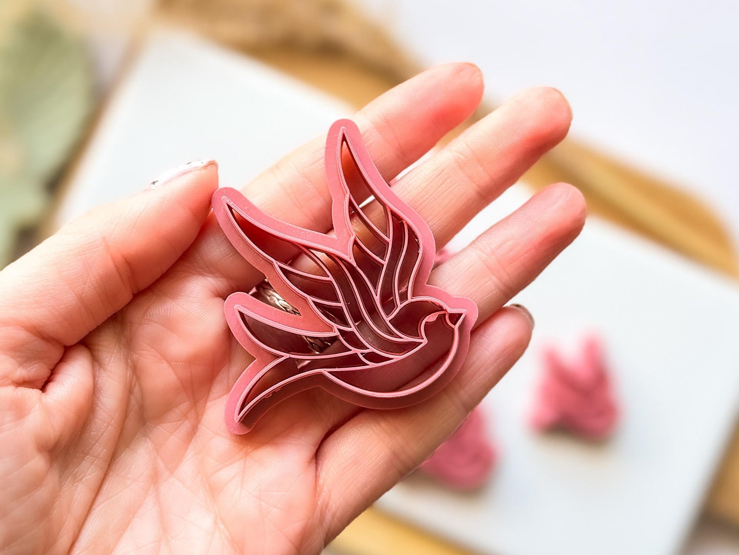Close up of medium sized swallow or sparrow bird clay cutting tool
