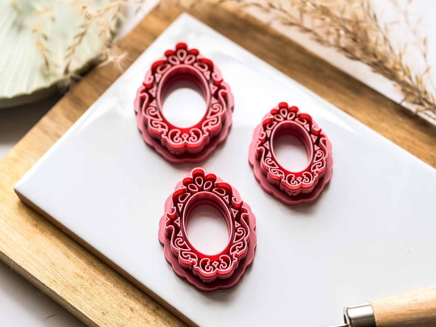 Tilting view of three sizes of frame clay earring cutter