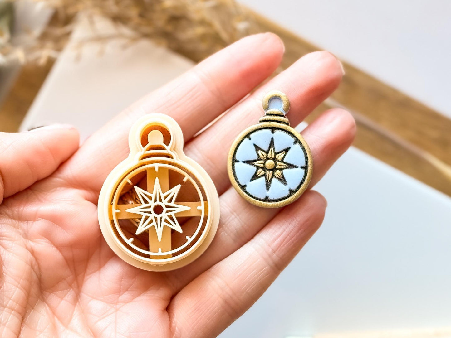 beige nautical compass clay cutter in hand