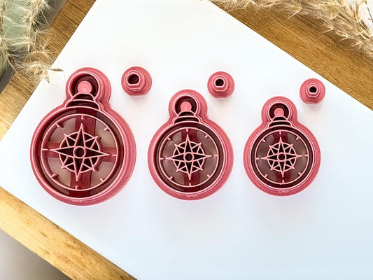 3 sizes of pink compass clay cutter on a white tile