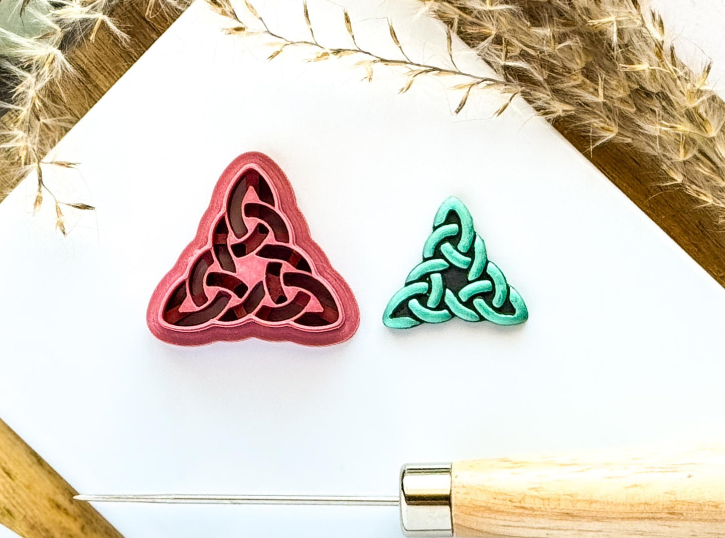 Celtic Triangle clay cutter in pink on white tile