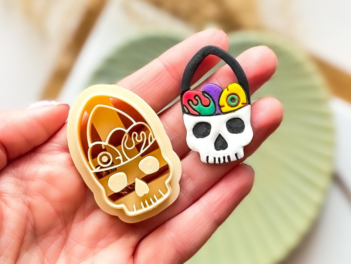 Close upof beige skull basket cutter with a cut out and painted clay sample