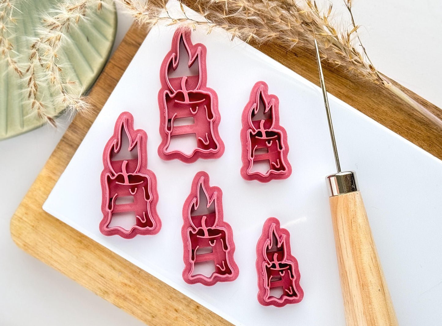 Polymer clay cutter in a melting candle shape with wick and flame