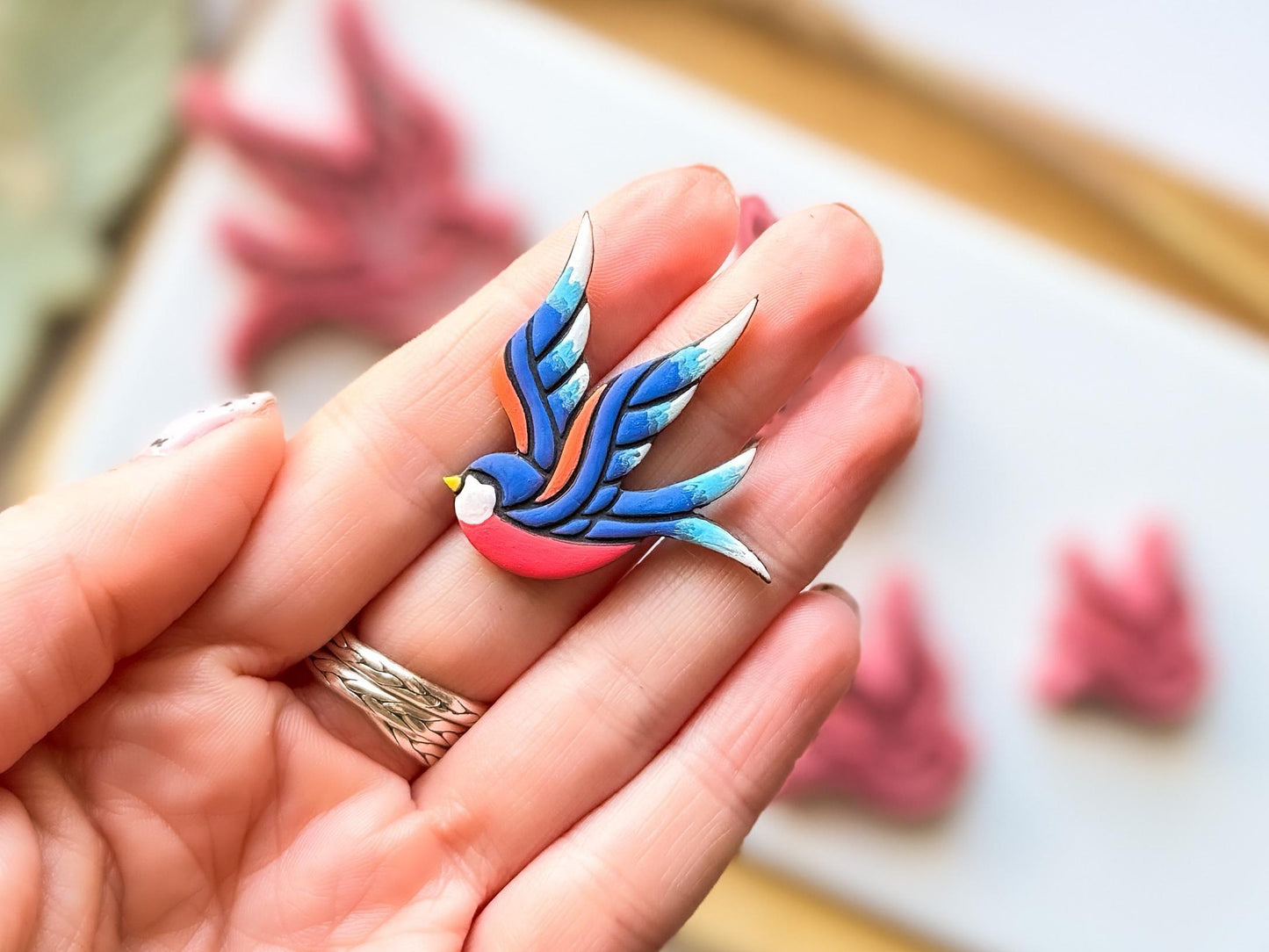 Close up of polymer clay shape cut using the Fabled swallow tattoo cutter