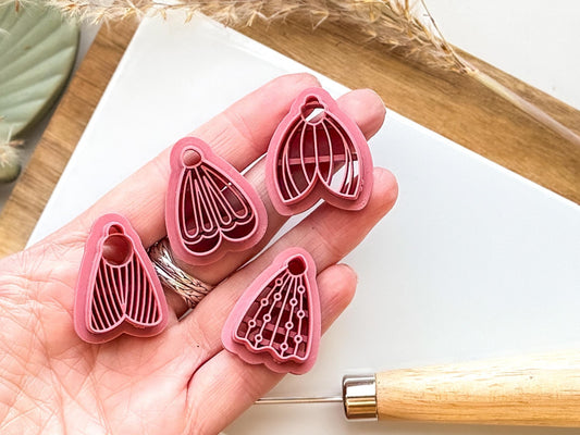 moth cutter set for polymer clay being held in a hand for scale