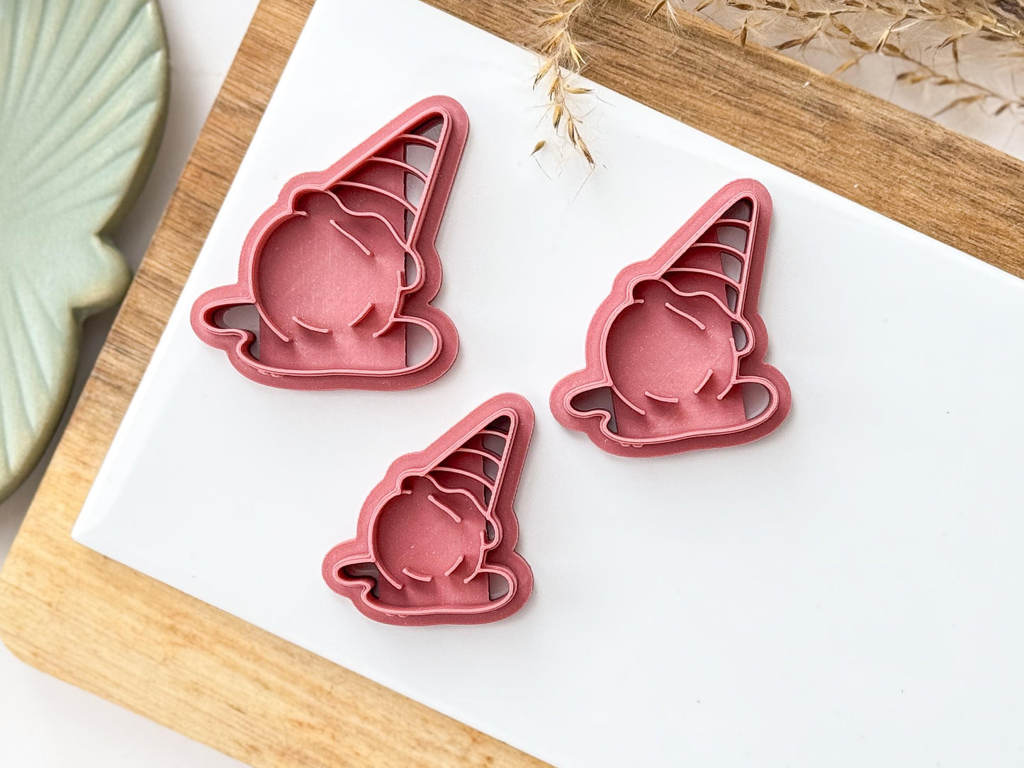 Various sizes of summer ice cream polymer clay cutter on a baking tile