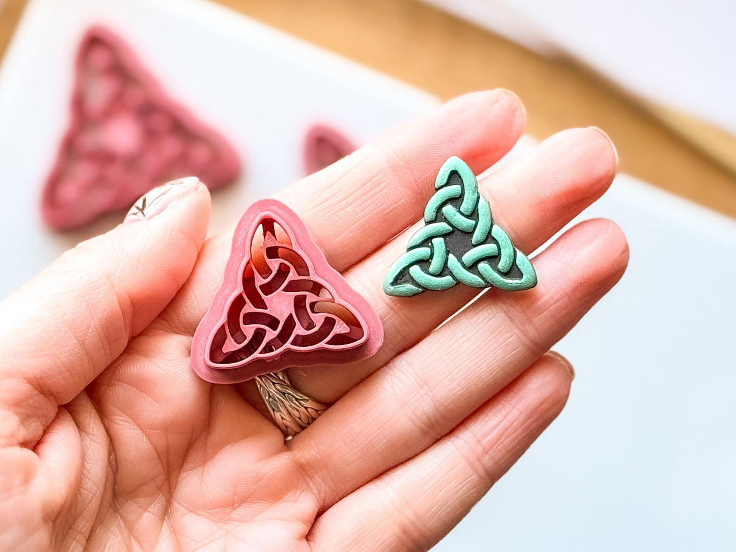 Triangle celtic polymer clay cutter in hand