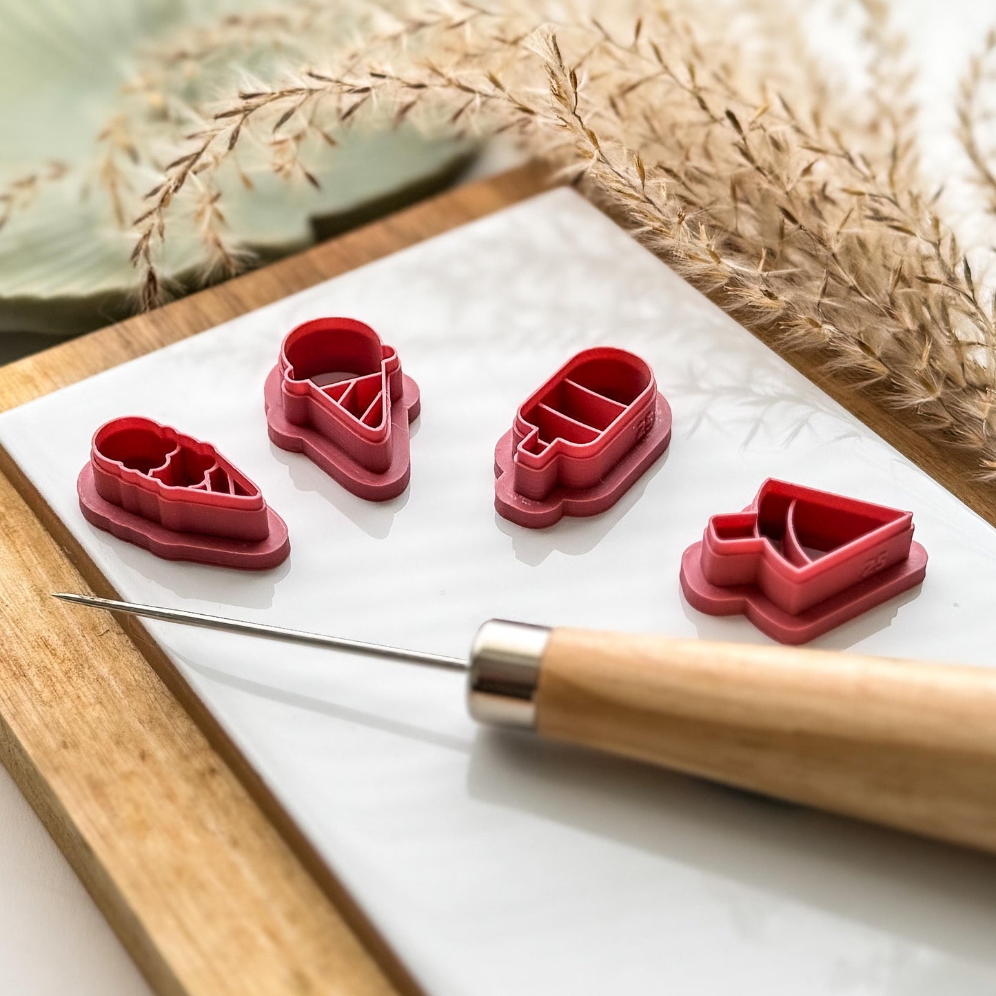 side view of 4 ice cream shaped clay cutters to show imprint line depth and cutting edge sharpeness