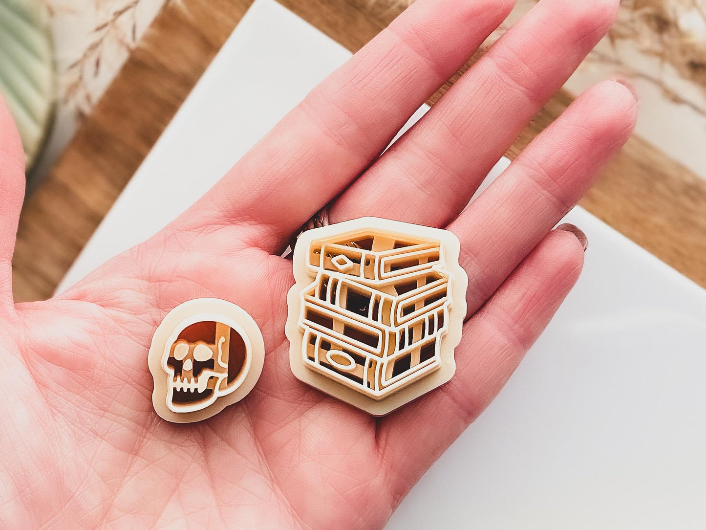 clay cutter set including 4 stacked books and a skull