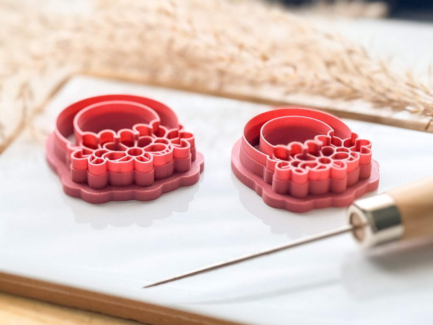 Side view of two 3d printed daisy clay cutters to show the imprint line depth.