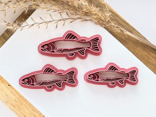 various sizes of trout fish polymer clay cutter with face and pattern stamp details.