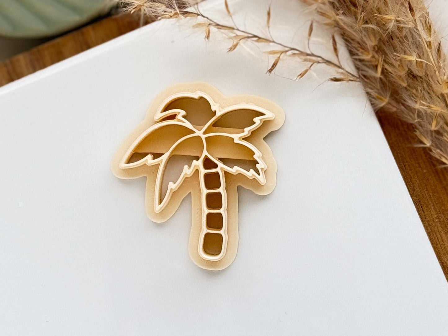 close up of beige coconut tree clay cutter