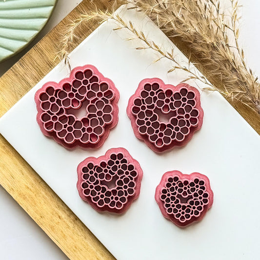 various sizes of daisy heart clay cutter in dark pink