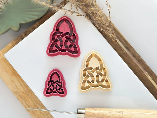 Three sizes of triangle celtic knot style clay cutter in pink and beige