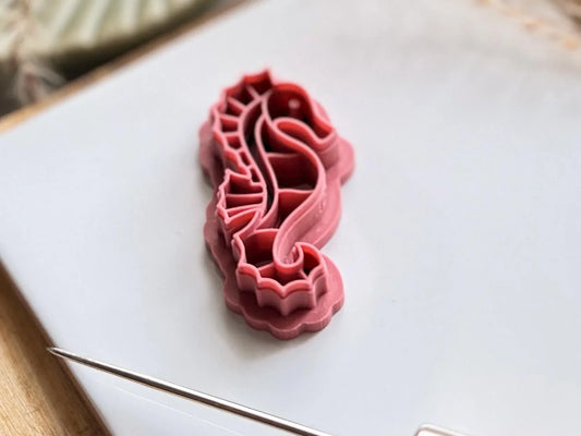 tilted view of seahorse clay cutter with curled tail and fins