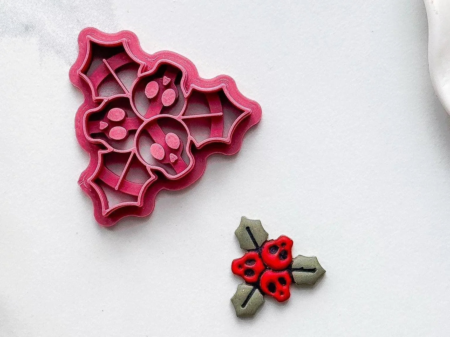 dark matte pink gothic Christmas jewellery tool for metal clay and polymer clay on marble background.