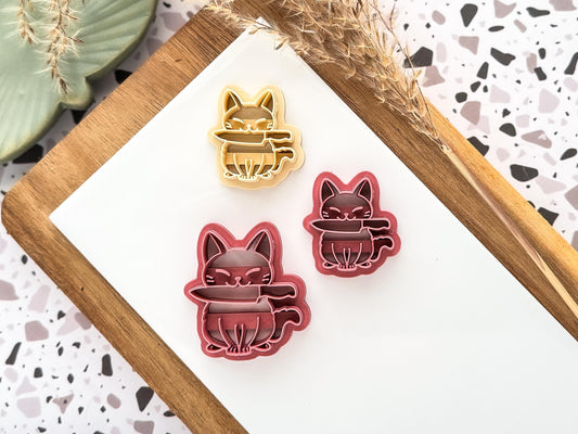 sitting cat with knife clay cutters in small and large sizes
