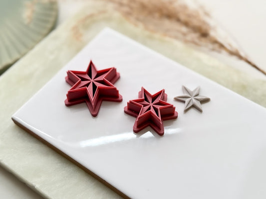 Side view of six point star clay cutters in emo witchy style with debossed sections.