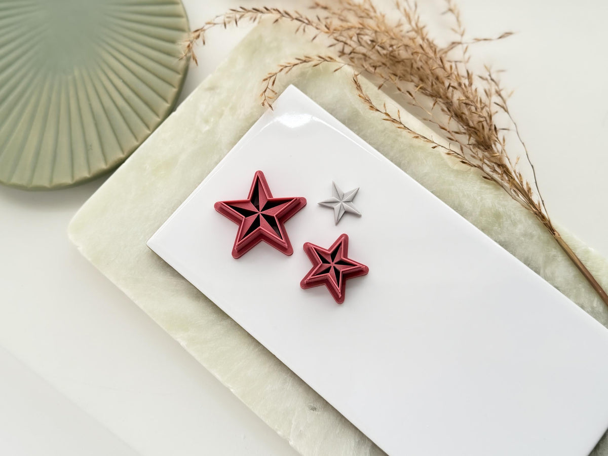 Five point star shaped clay and fondant cutter with emo or nautical style debossed sections. Next to the cutter sis a polymer clay cut out sample