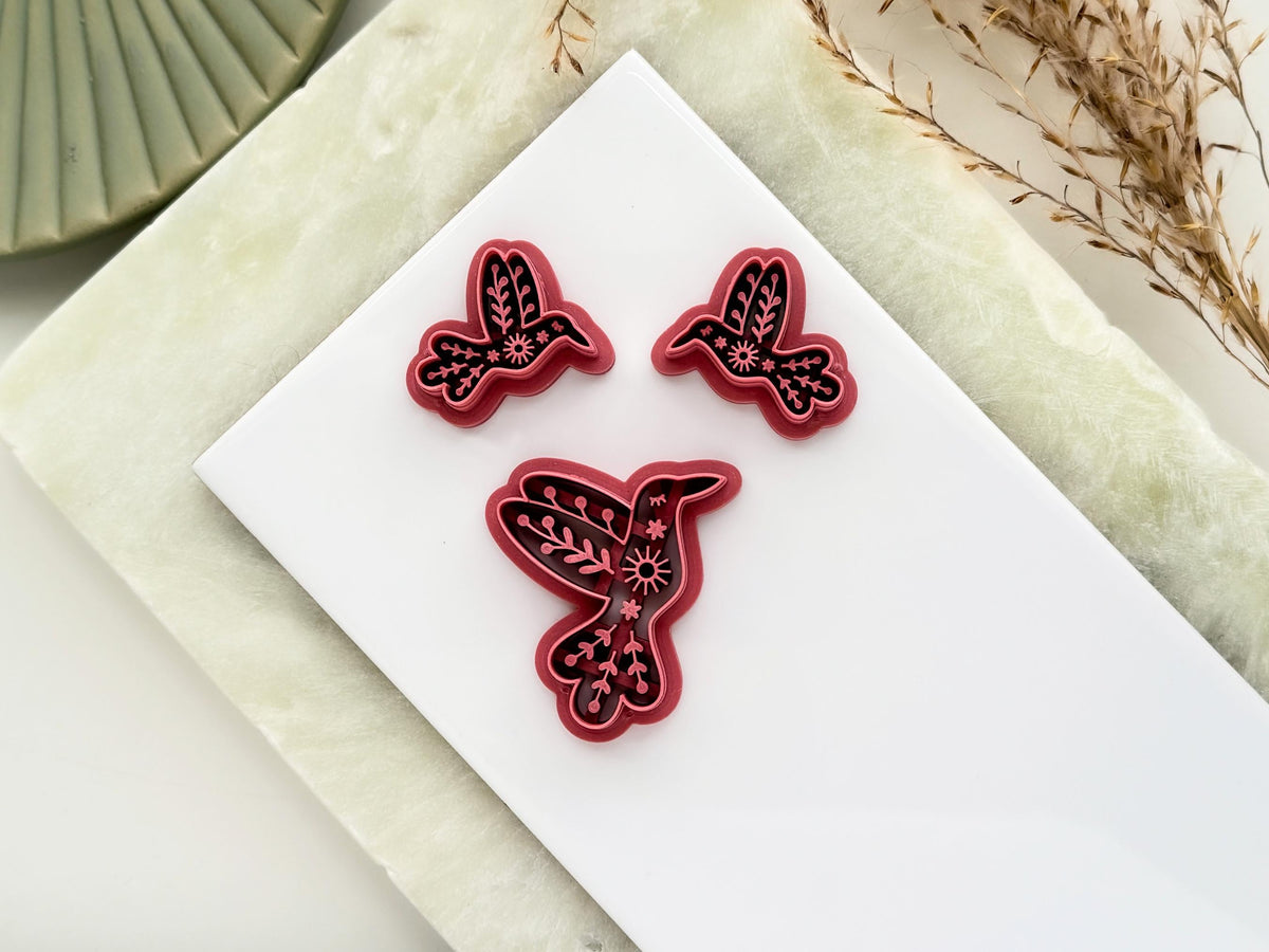 3 hummingbird clay cutters with nordic style imprint patterns. This image features a single large cutter and smaller mirrored pairs for earring and jewellery making