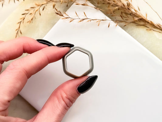 6 sized hexagon shaped outline cutter being held in a hand