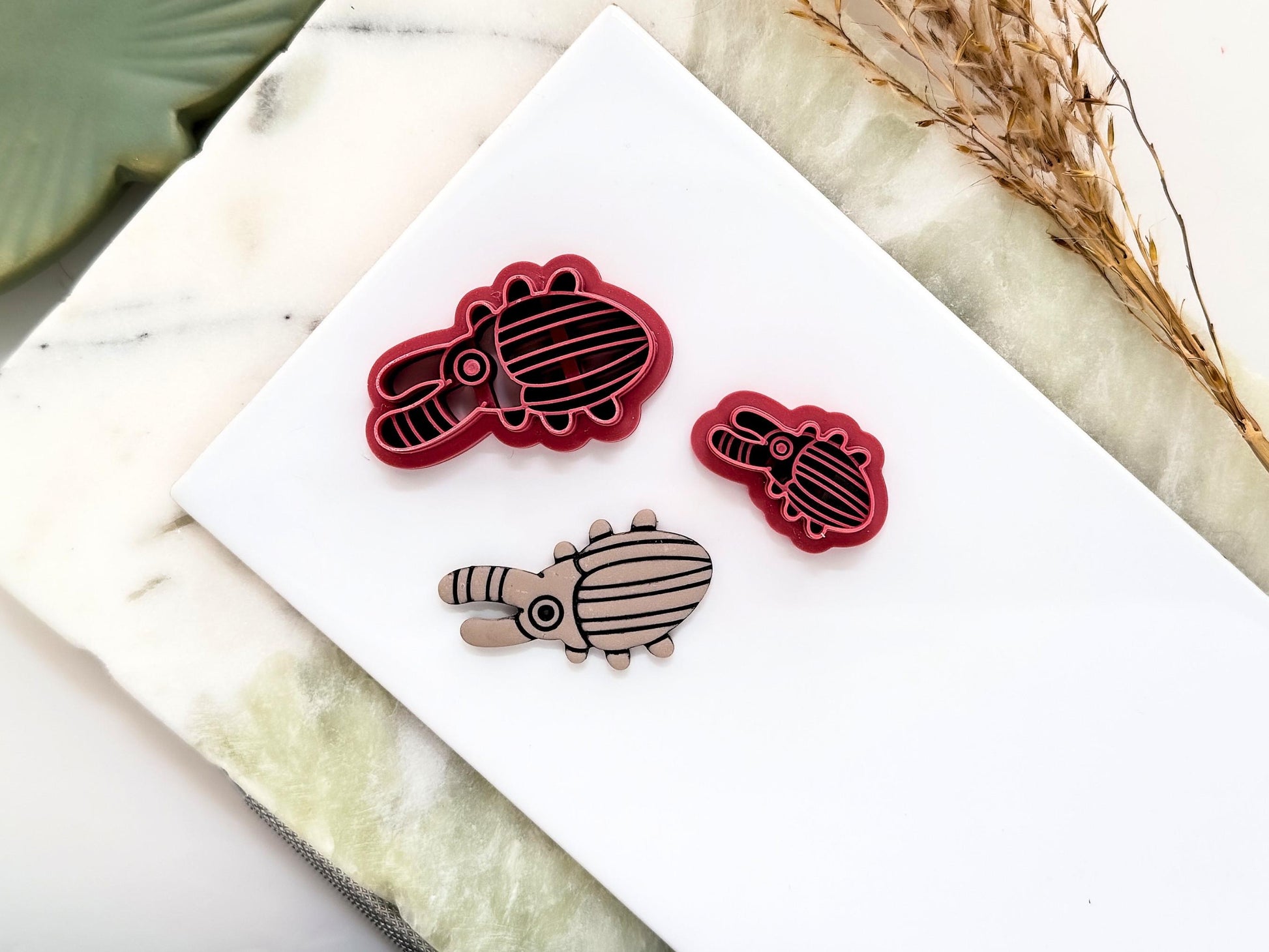 Stag beetle shaped clay cutter in a funky abstract style. The cutter features a striped horn and striped closed wings.