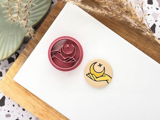 Boho or celestial themed circular clay cutter with hand moon and star stamp details