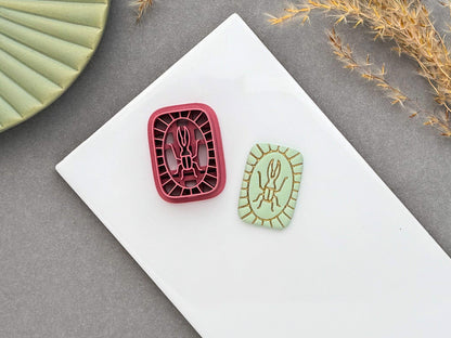 Beetle polymer clay cutter displayed beside a matching finished polymer clay embellishment featuring a simple beetle motif with an Art Deco-inspired geometric border.