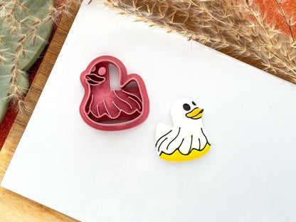 Duck shaped halloween cutter for polymer clay with eye, beak and sheet stamp details. 
