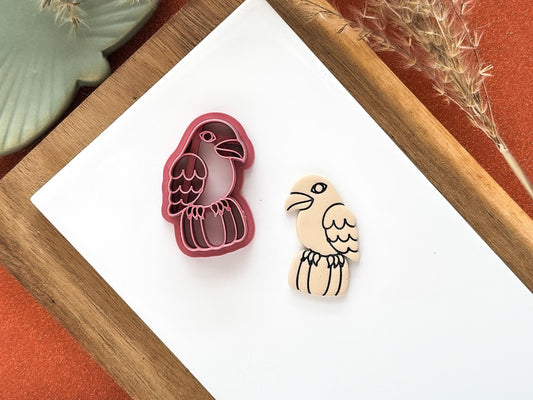 halloween polymer clay cutter in the shape of a crow sitting on a pumpkin