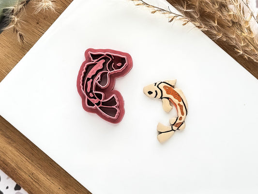koi fish shaped embossing cutter with polymer clay cut out sample.