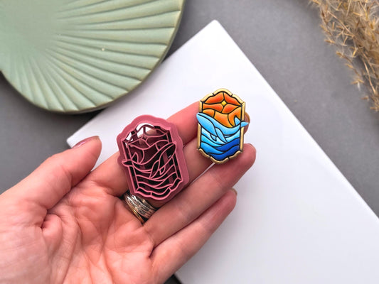 Stained glass whale polymer clay cutter  in 3.5 cm size held beside a finished whale earring to show detail and finished result.