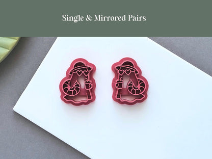 Single and mirrored pair summer ghost character polymer clay cutters displayed side by side on a white ceramic tile. The festive design features a pool floatie, hat and cocktail detail and is suitable for creating matching left and right clay pieces.