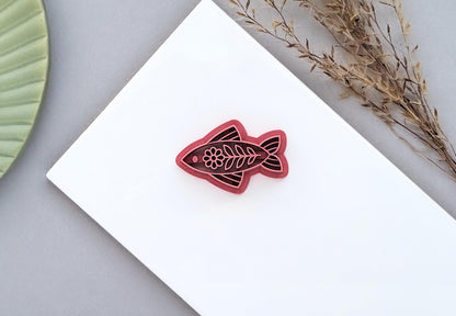 Floral folk art style fish-shaped polymer clay cutter with intricate stamp details for making earrings and jewellery.