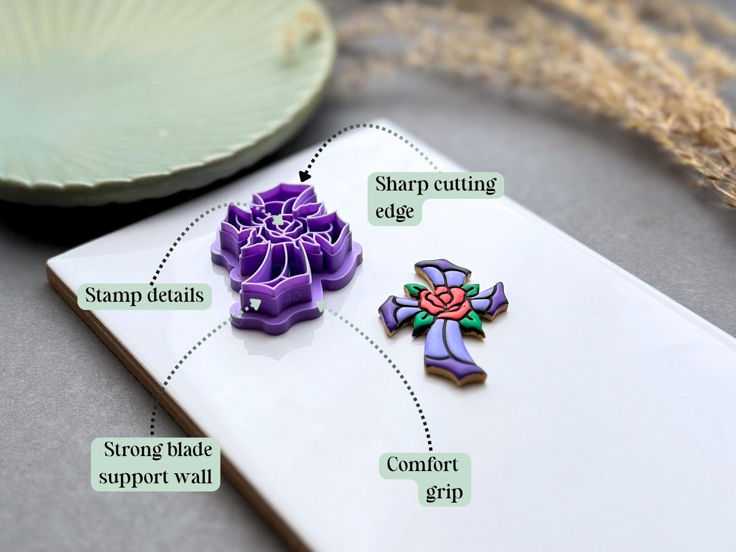 Diagram showing the sharp cutting edge, stamp details, strong blade support wall and comfort grip of the stained glass cross with rose polymer clay cutter.