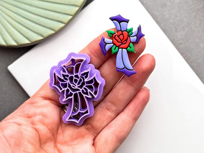 Hand holding gothic rose cross polymer clay cutter beside finished stained glass clay embellishment for scale – Fabled Cutters