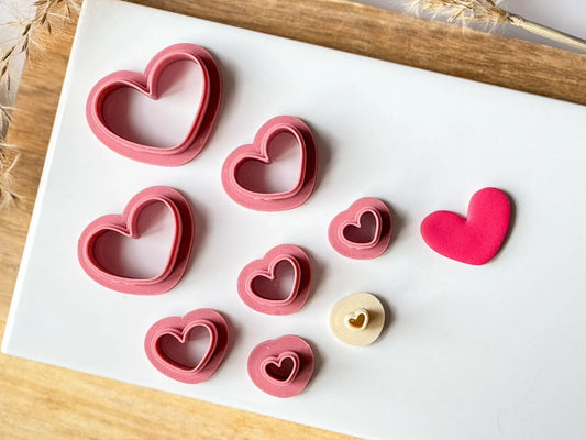 Large and small heart clay cutters on tile