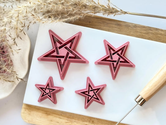 Pentagram star witchcraft polymer clay cutter in all available sizes surrounding clay piece made with the tools.