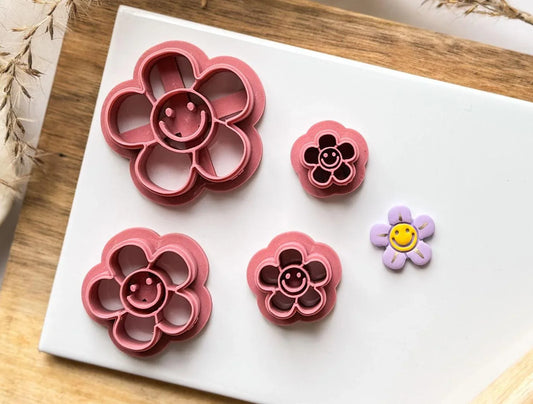 preppy smiley flower clay cutters on tile with cut of polymer clay example