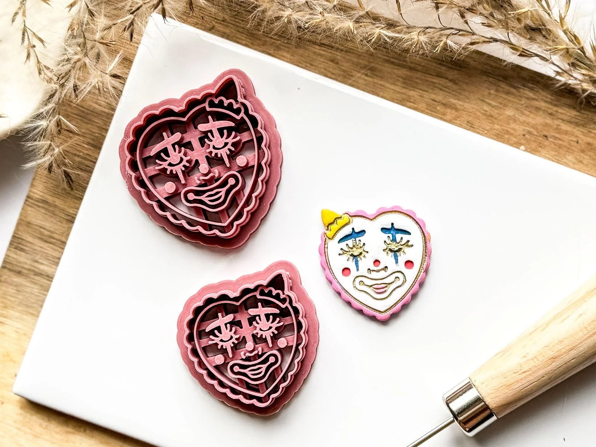 heart clown detailed clay cutter on white tile with sample clay