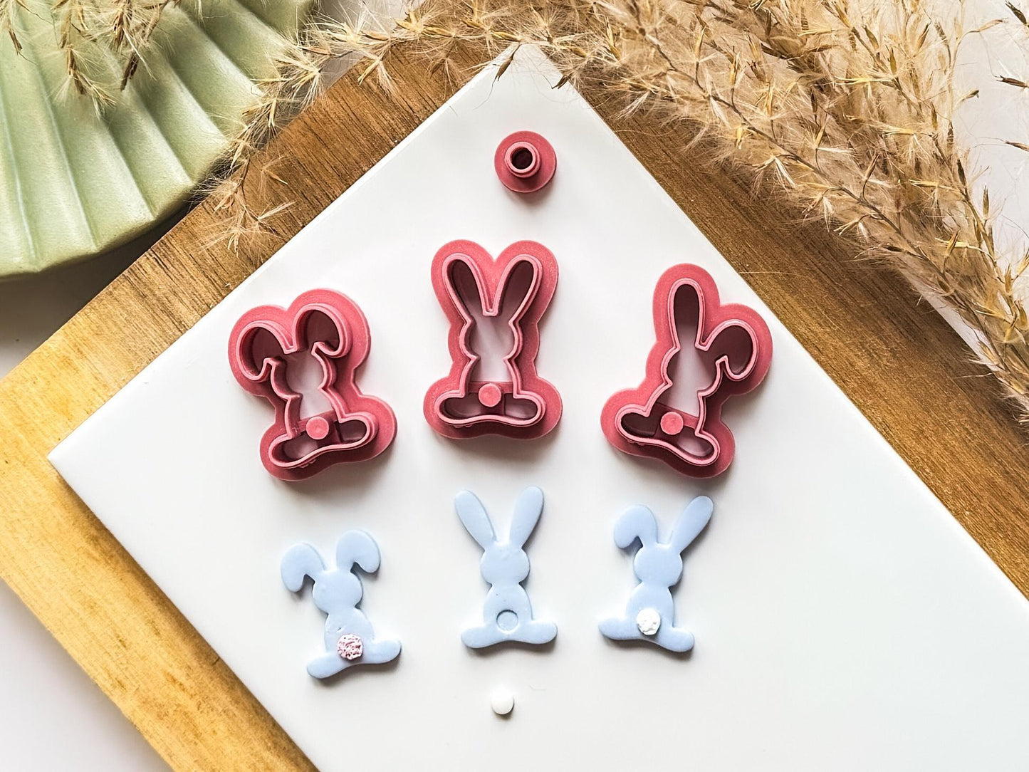 Easter clay cutter bunny set in dark pink on a white baking tile with cut out samples